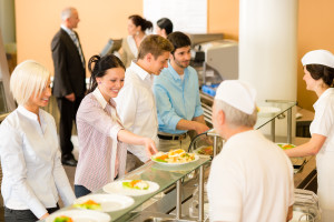 Business colleagues in cafeteria cook serve fresh healthy food m